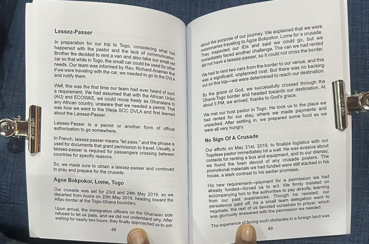 A person holding an open book, relevant to